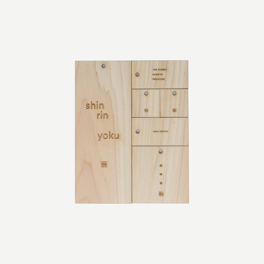 Wooden panel with engraved text on a white background