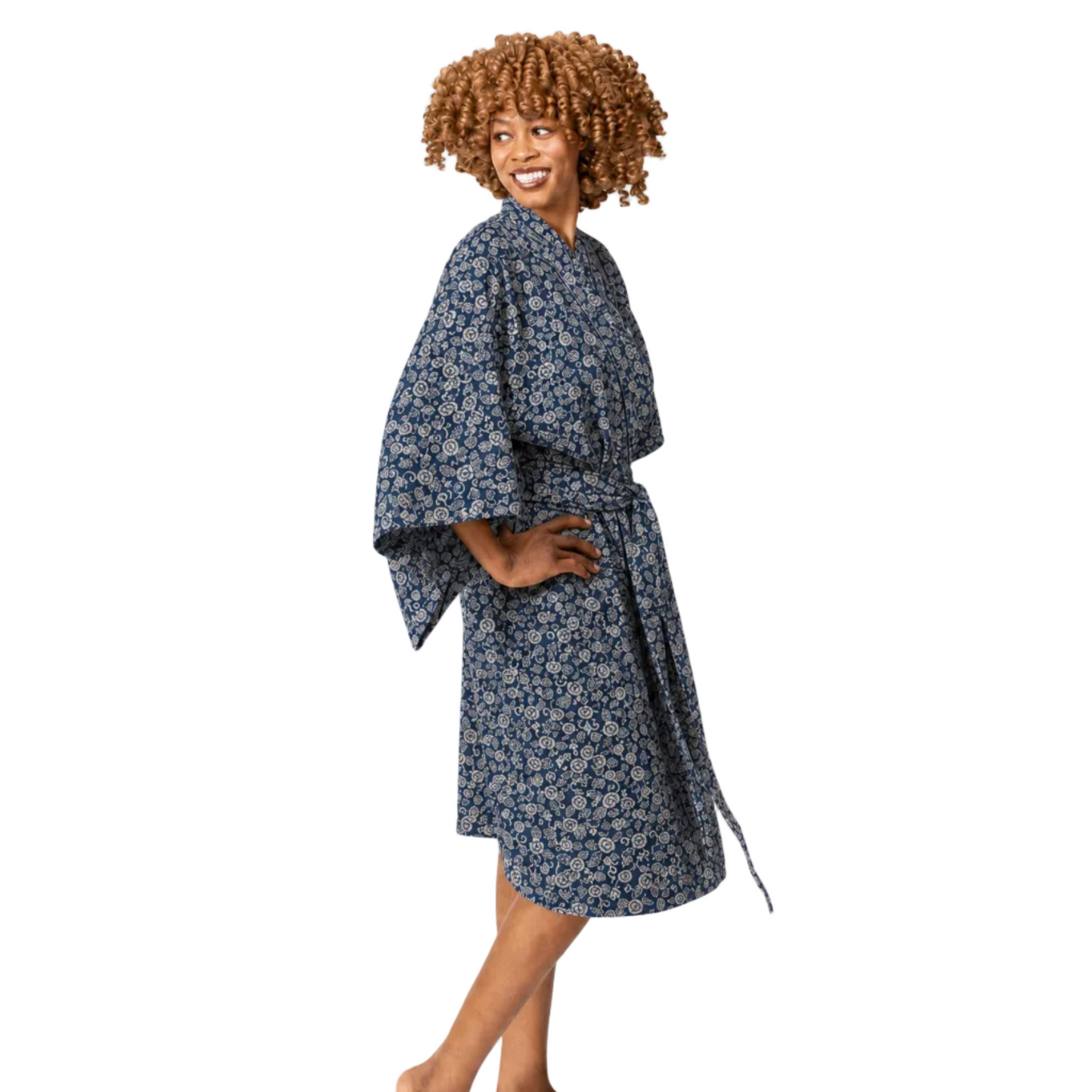 A woman modeling a blue and white floral print kimono-style robe against a plain white background.