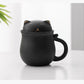 Black cat-shaped mug with a lid on a white surface