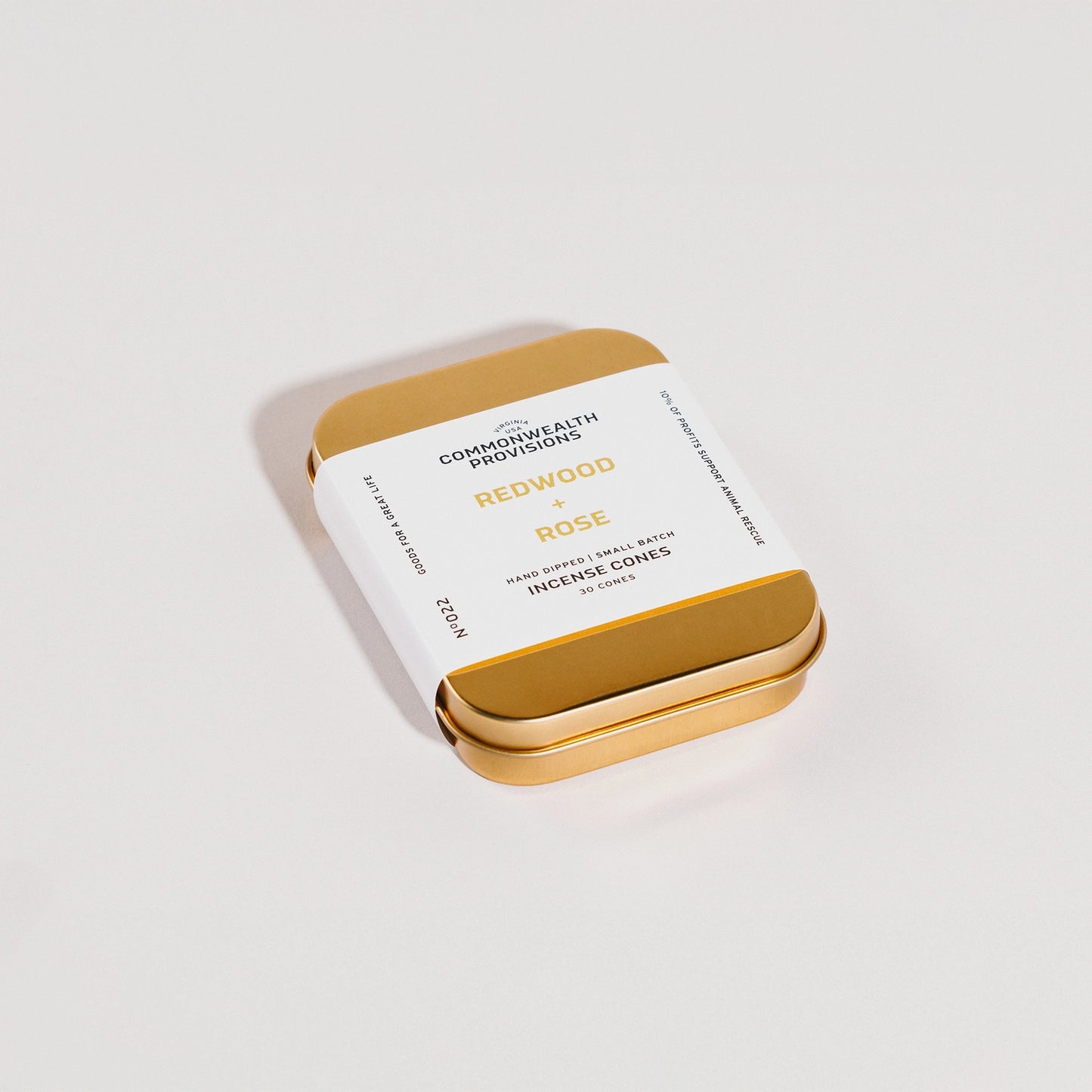 Gold tin with white label on a light gray background