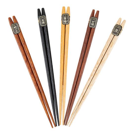 A set of five pairs of reusable chopsticks made from wood, displayed on a white background. Each pair has a unique wood color tone, ranging from light beige to dark brown, and they all feature decorative metal accents at the top.