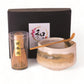 Tea-making set with a whisk, bowl, and box on a white background