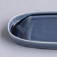Blue ceramic tray on a light gray background