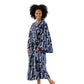 A woman modeling a navy blue and white abstract patterned bathrobe against a plain white background.