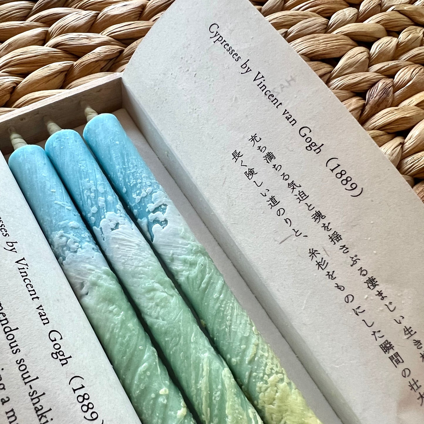 Close up of three candles with textured blue and green wax.