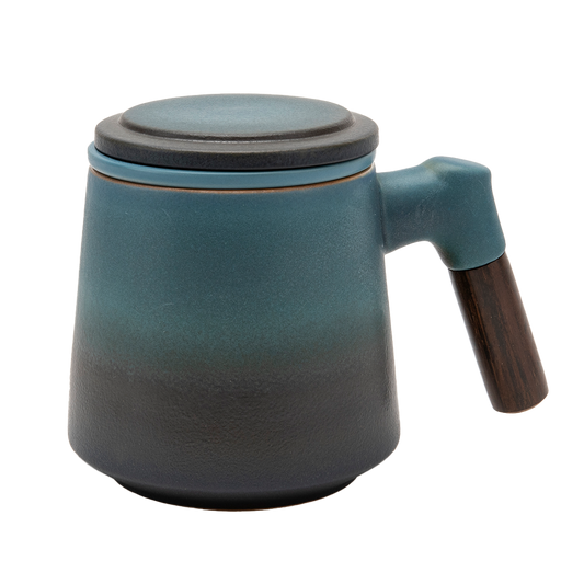 A blue ceramic tea infuser cup with a removable lid and a wooden handle.