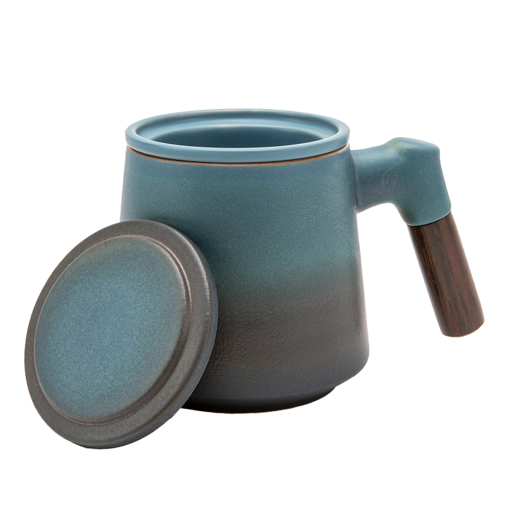 A blue ceramic tea infuser cup with a removable lid and a wooden handle.