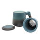 A blue ceramic tea infuser cup with a removable lid and a wooden handle.