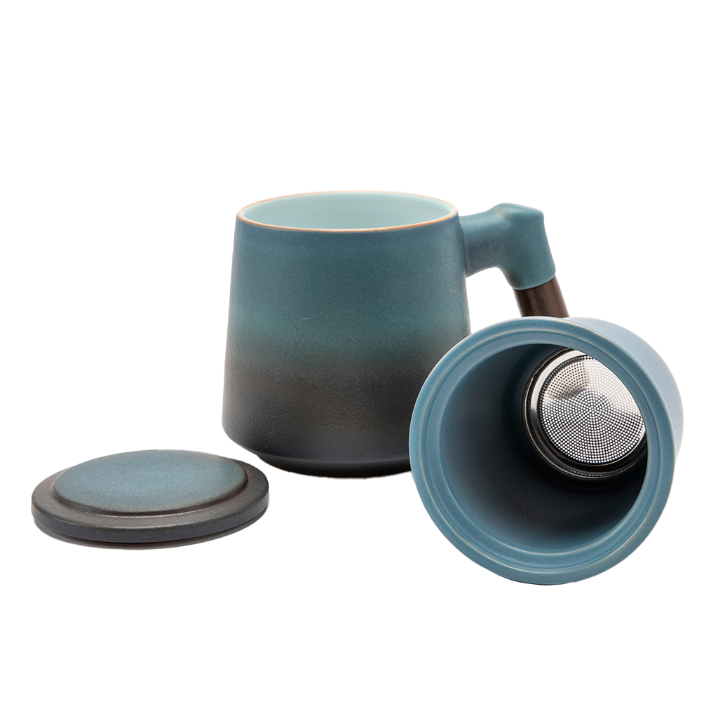 A blue ceramic tea infuser cup with a removable lid and a wooden handle.