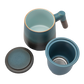 A blue ceramic tea infuser cup with a removable lid and a wooden handle.