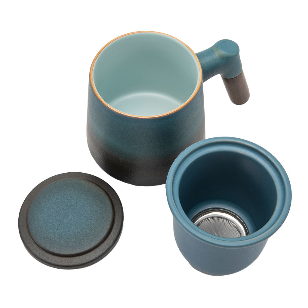 A blue ceramic tea infuser cup with a removable lid and a wooden handle.
