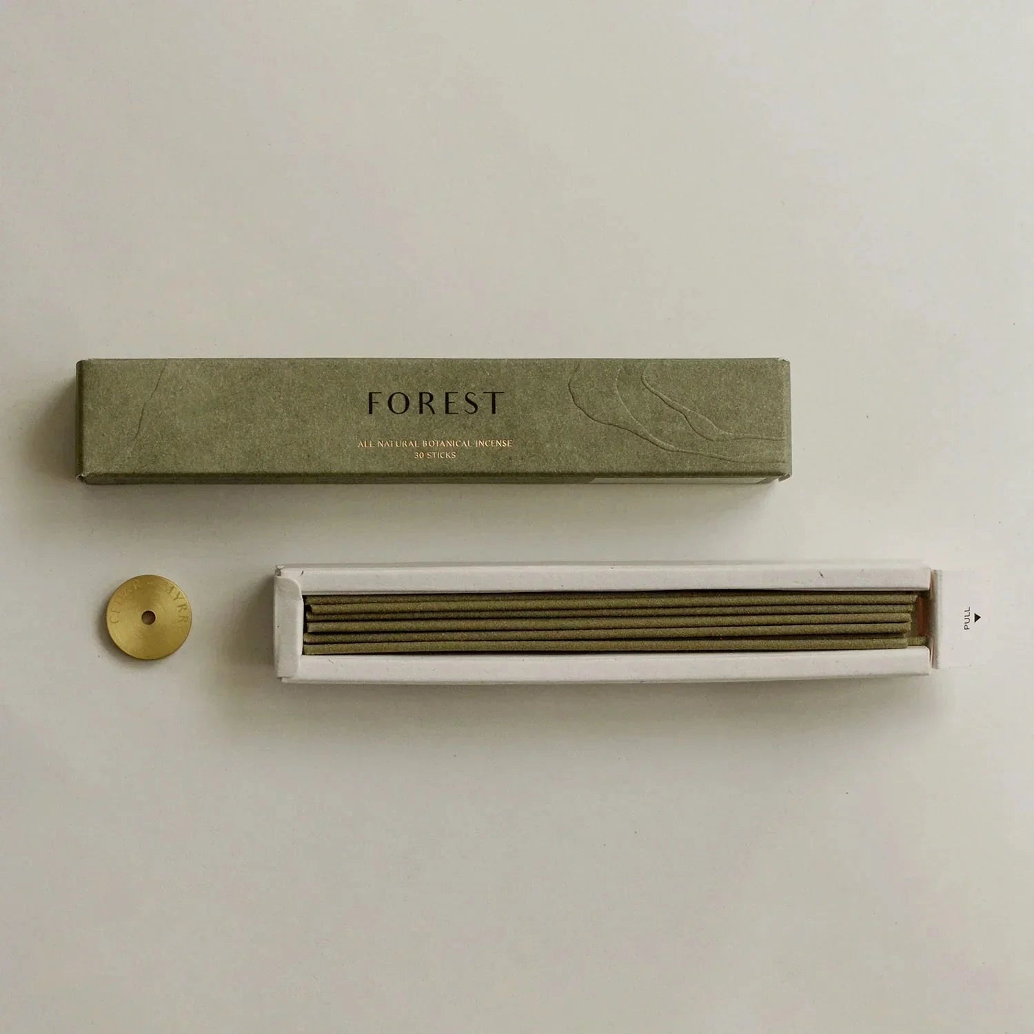 Green packaging box labeled 'FOREST' with a white device on a beige background