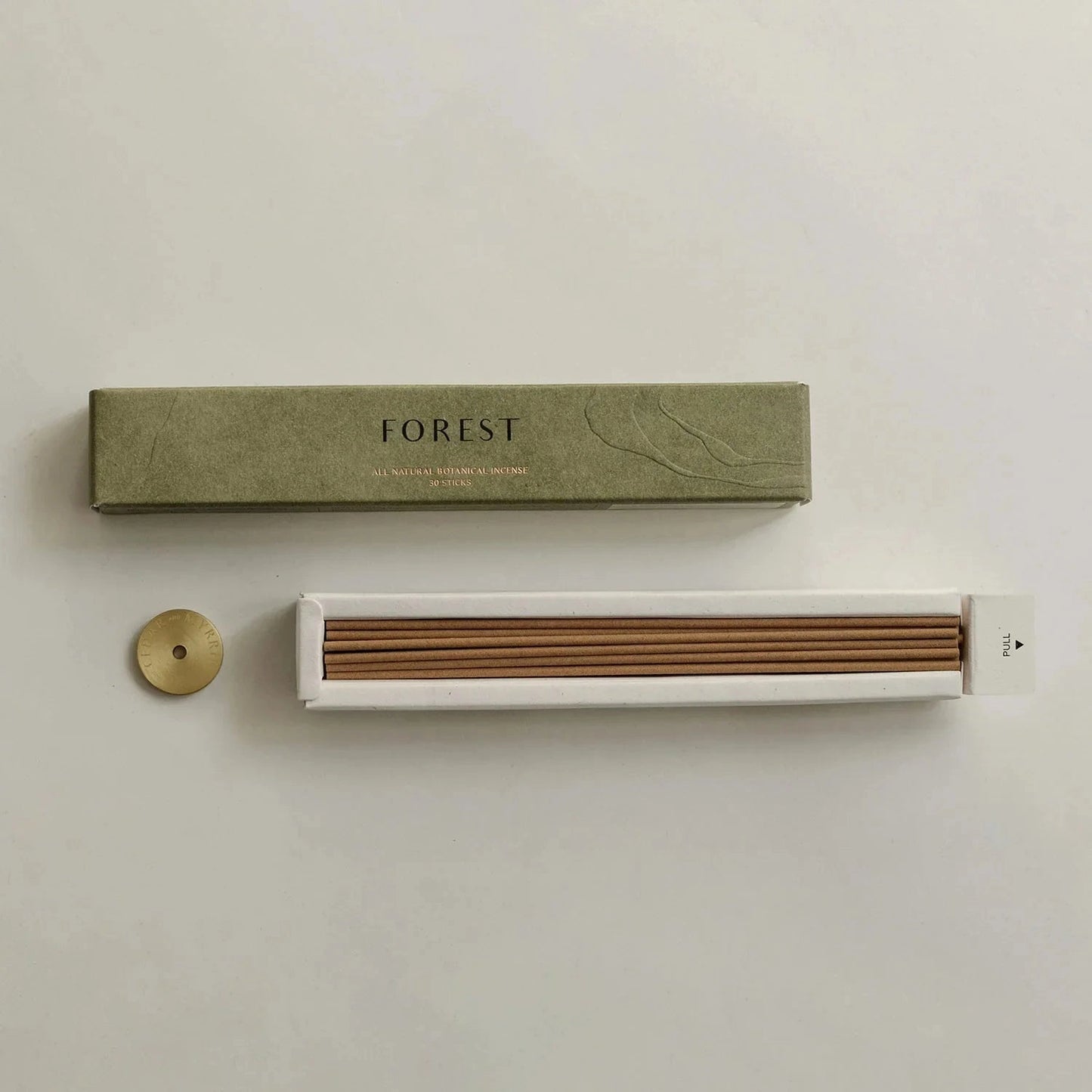 Incense set with 'FOREST' packaging on a light background
