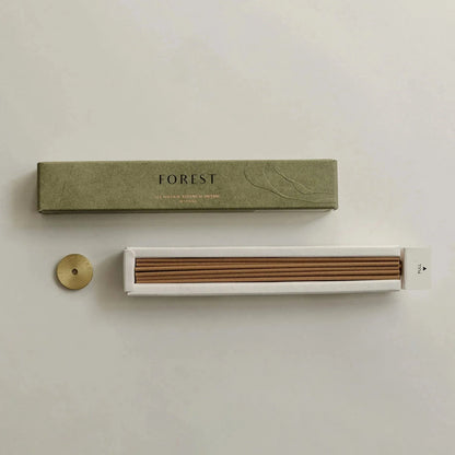 Incense set with 'FOREST' packaging on a light background
