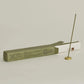 Incense stick and packaging on a light gray background