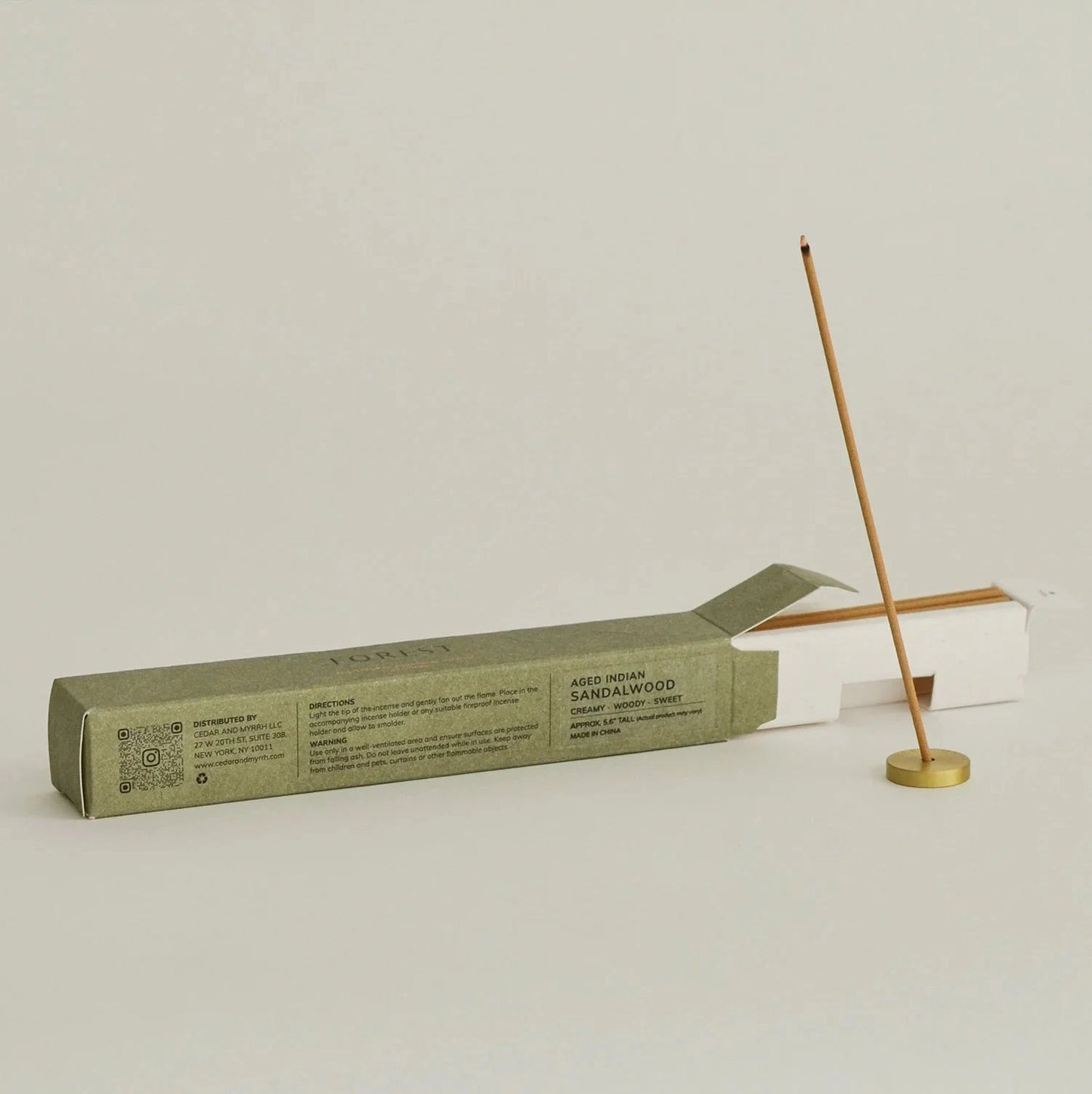Incense stick with packaging on a light gray background