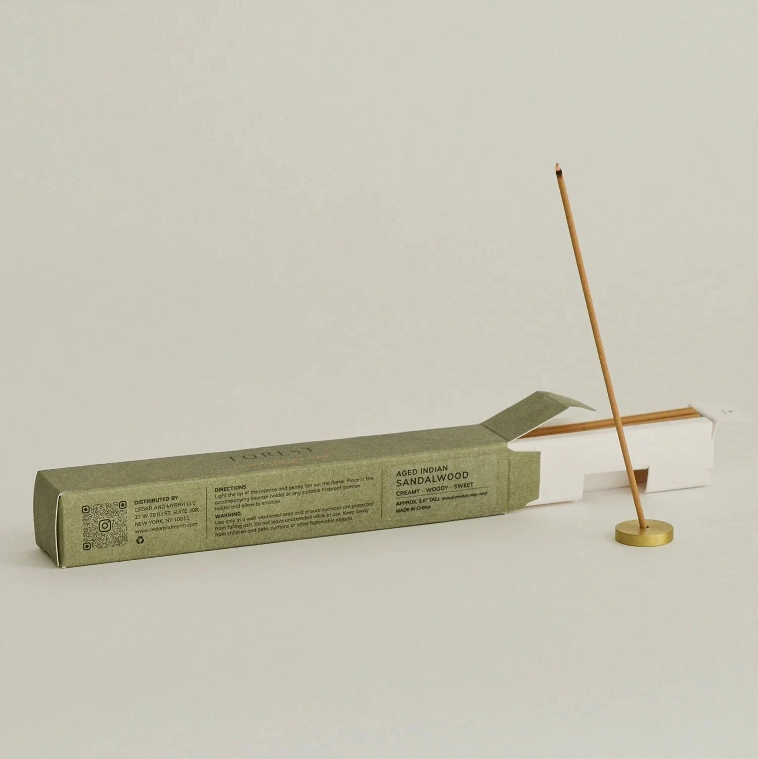 Incense stick with packaging on a light gray background