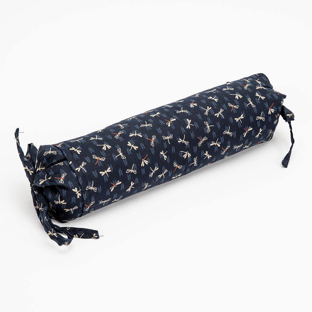 Buckwheat neckroll pillow with dragonfly pattern on a white background