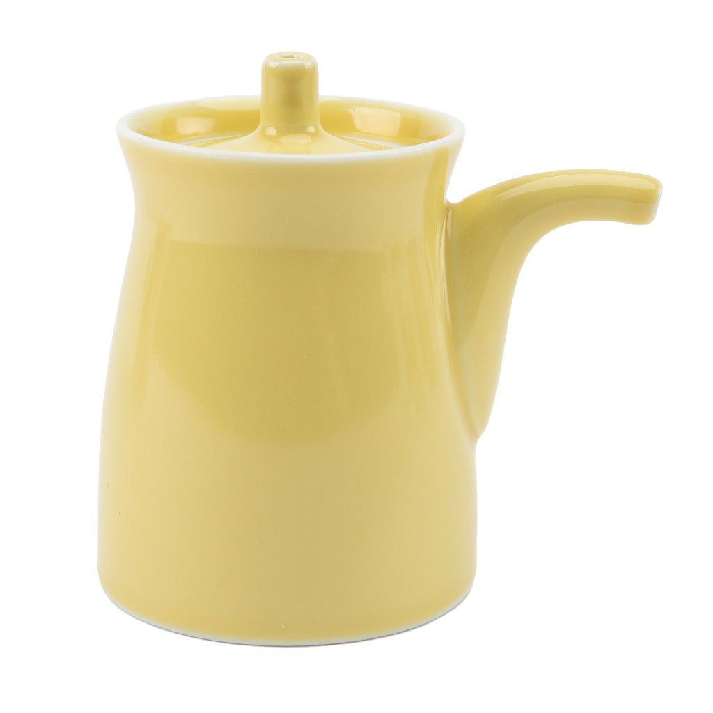Yellow ceramic soy sauce dispenser on a white background