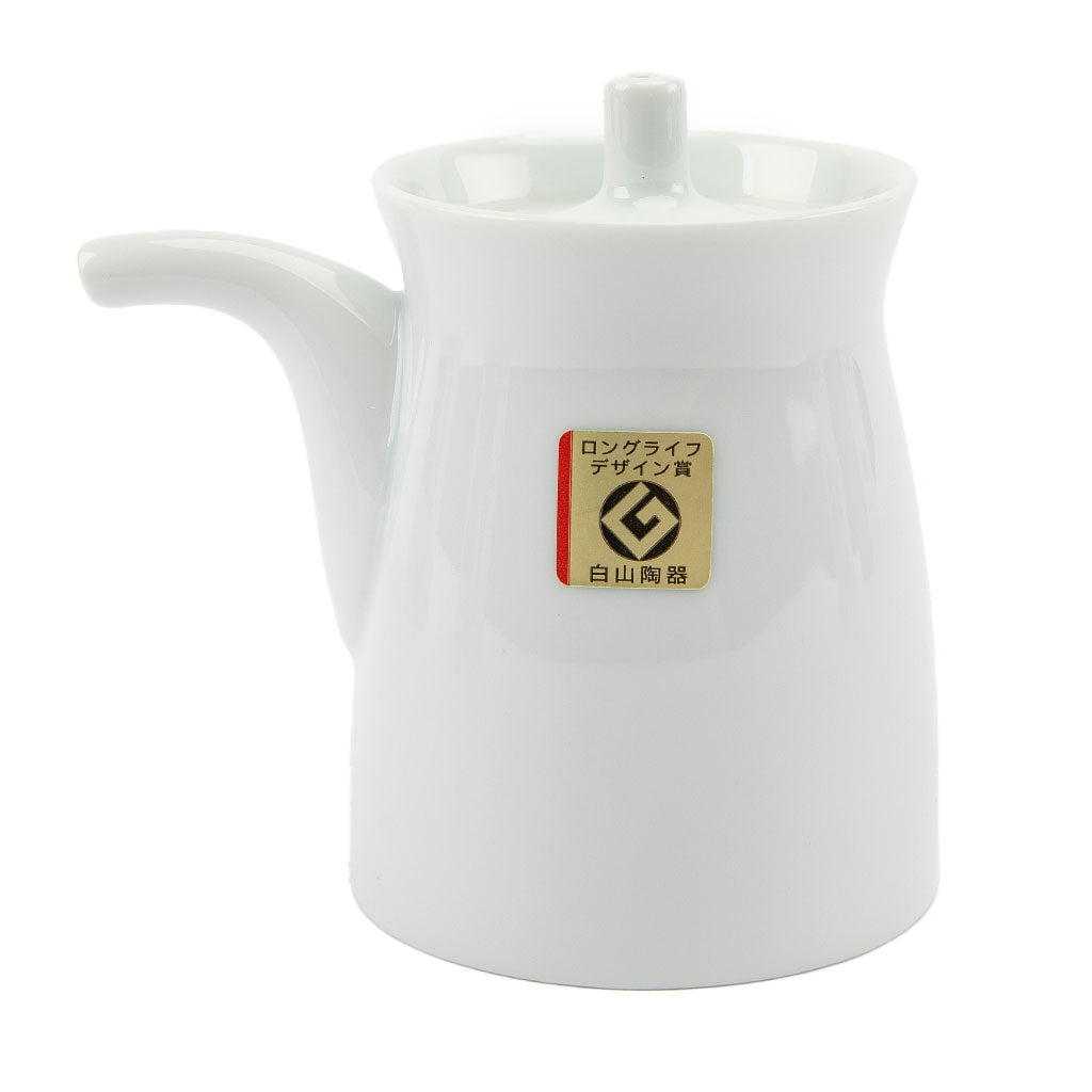 White ceramic soy sauce dispenser with a brand label on a white background