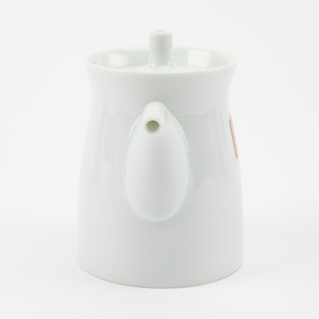 White ceramic soy sauce dispenser on a white background