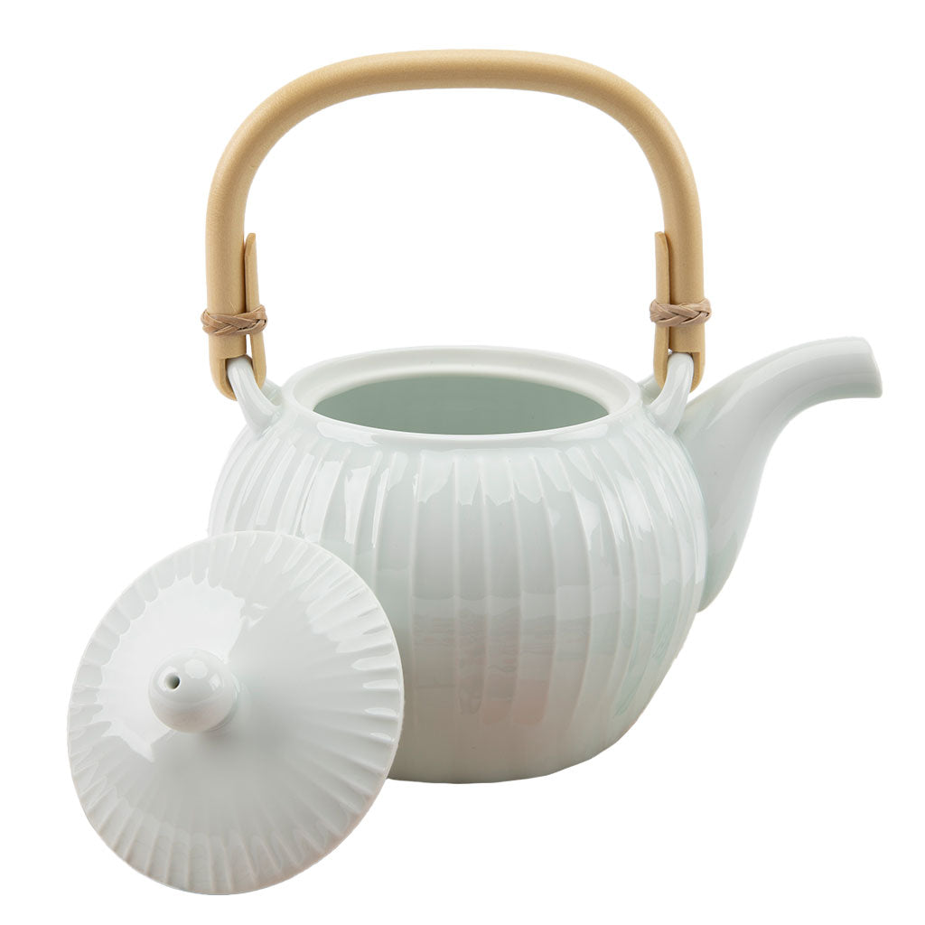 White ceramic teapot with a beige handle on a white background