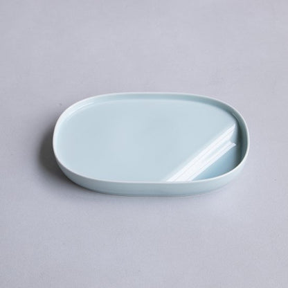 Light blue ceramic dish on a gray background