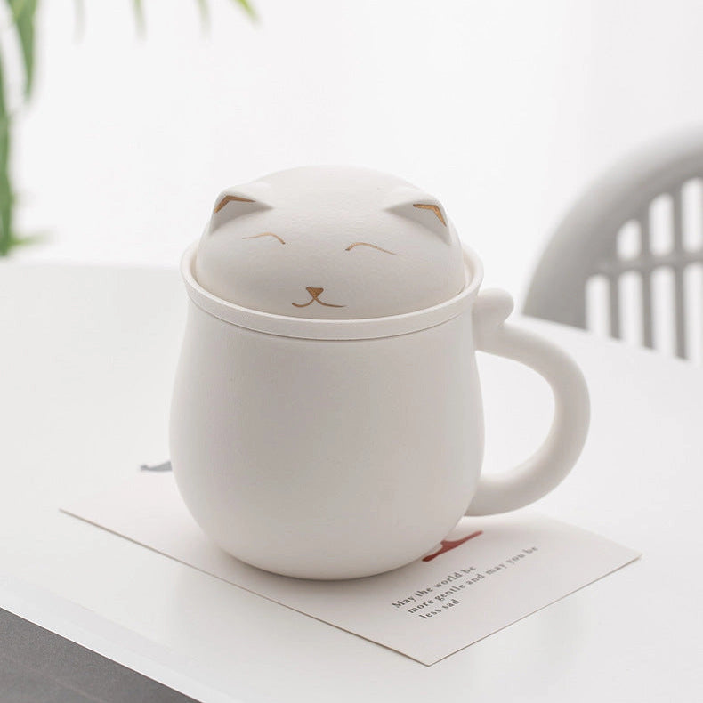 White ceramic mug with cat design on a white surface