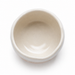A top-down view of a small, round ceramic bowl with a glossy, matte off-white finish, set against a plain white background.