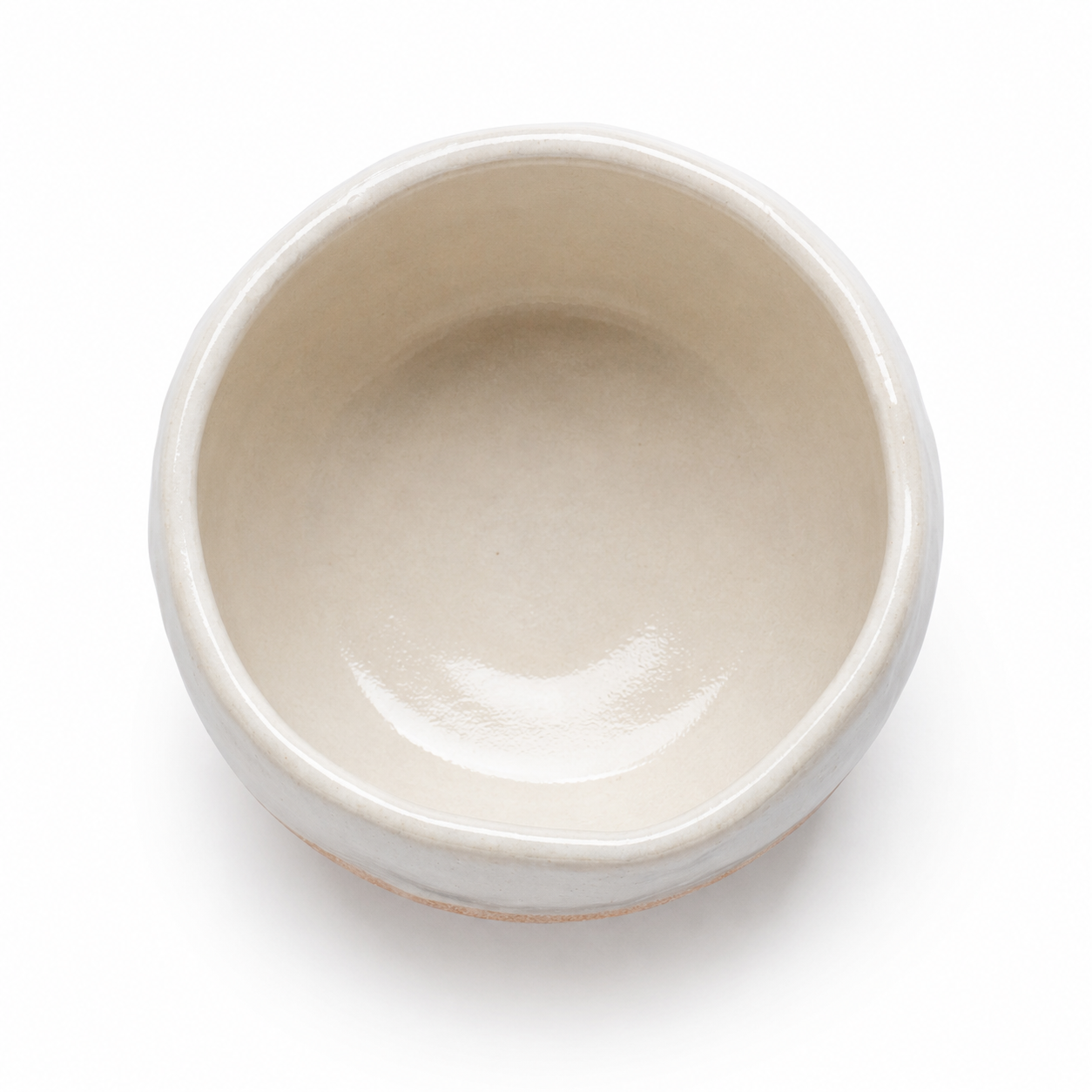 A top-down view of a small, round ceramic bowl with a glossy, matte off-white finish, set against a plain white background.