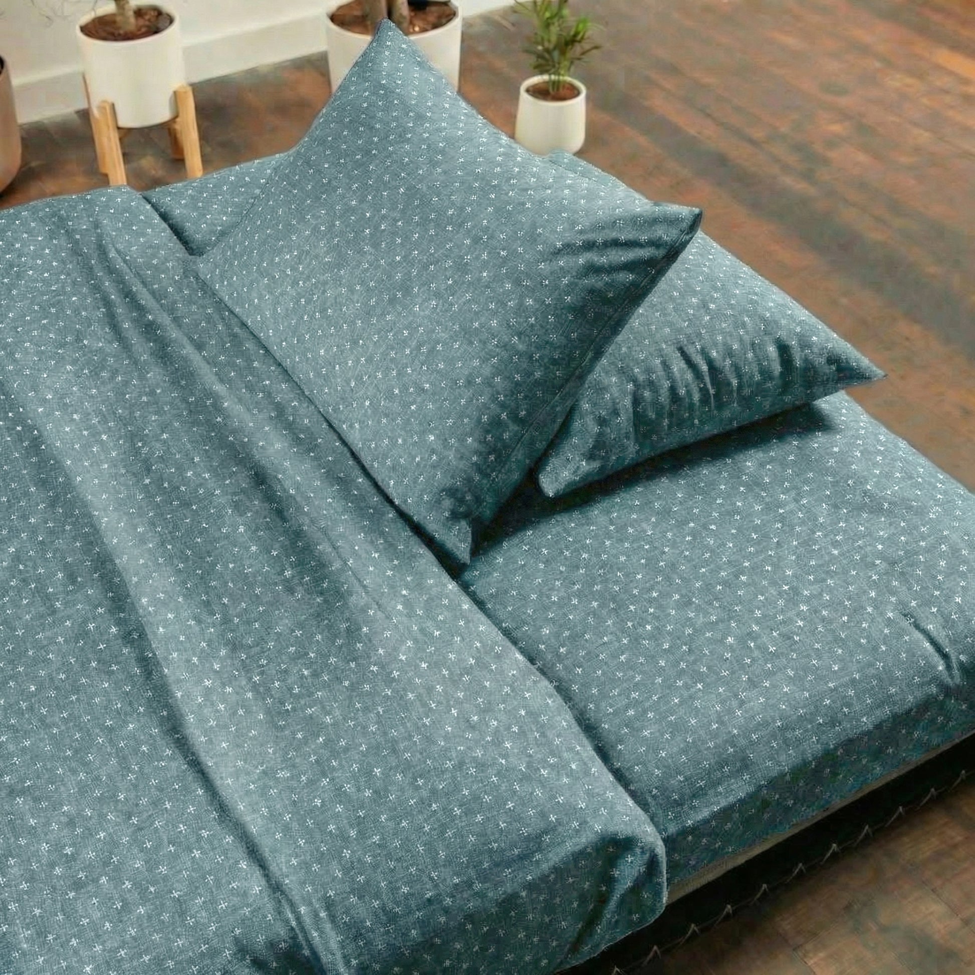 Teal bedding set on a tatami with plants in the background