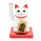 White cat figurine with red accents and gold emblem on a white background