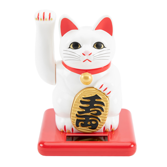 White cat figurine with red accents and gold emblem on a white background