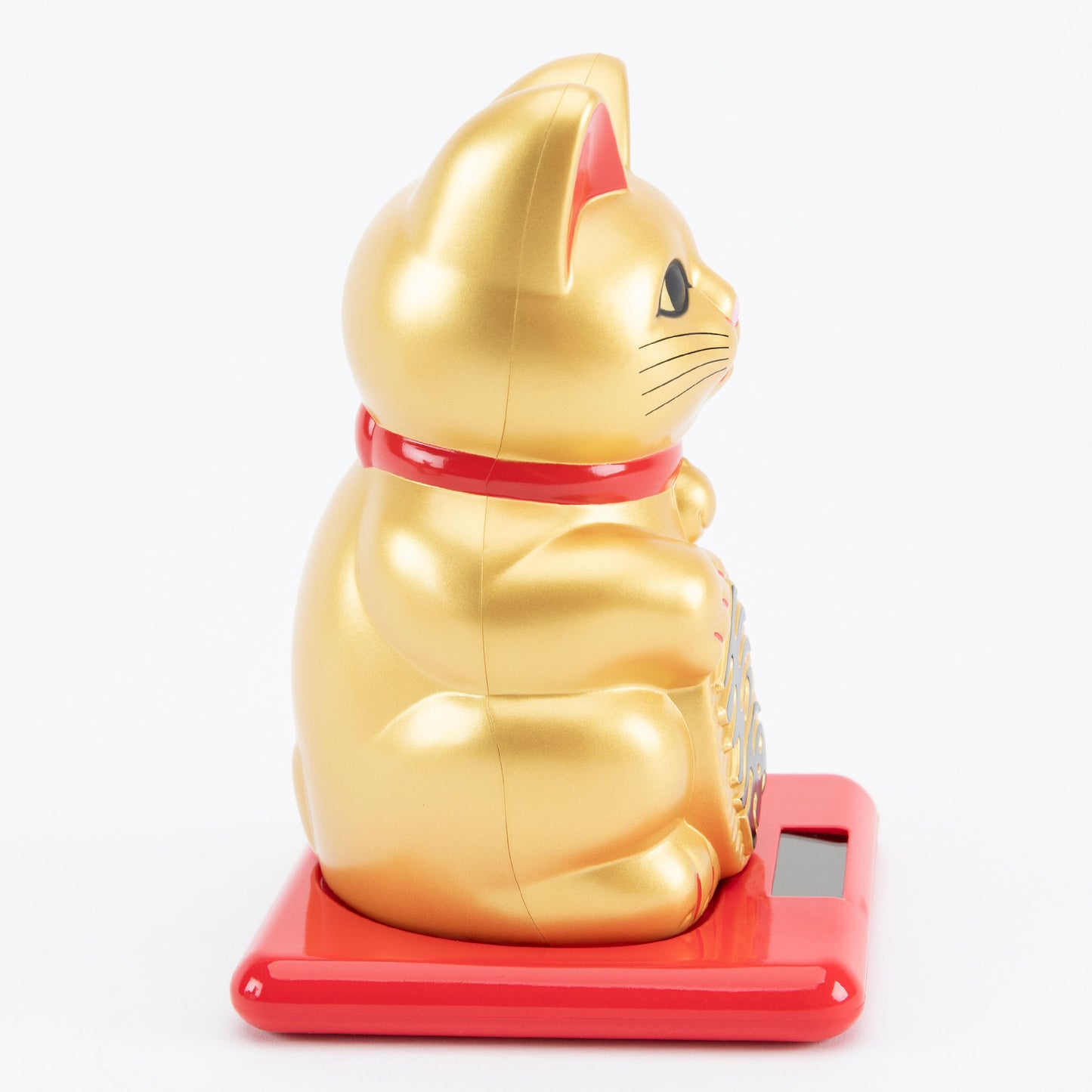Gold maneki-neko cat on a red base with a white background