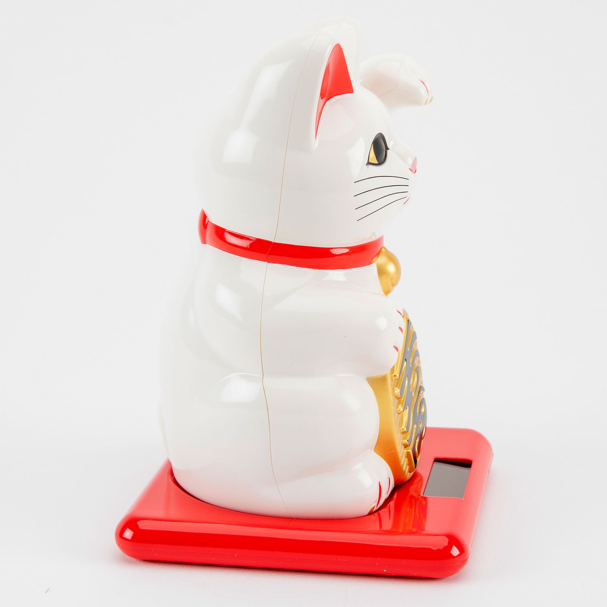 White maneki-neko cat on a red base with a white background