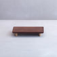 Wooden footstool with four legs on a white background