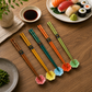 Lifestyle image of sushi and chopstick set on a wood table.