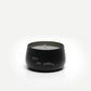 Black candle with white text on a white background