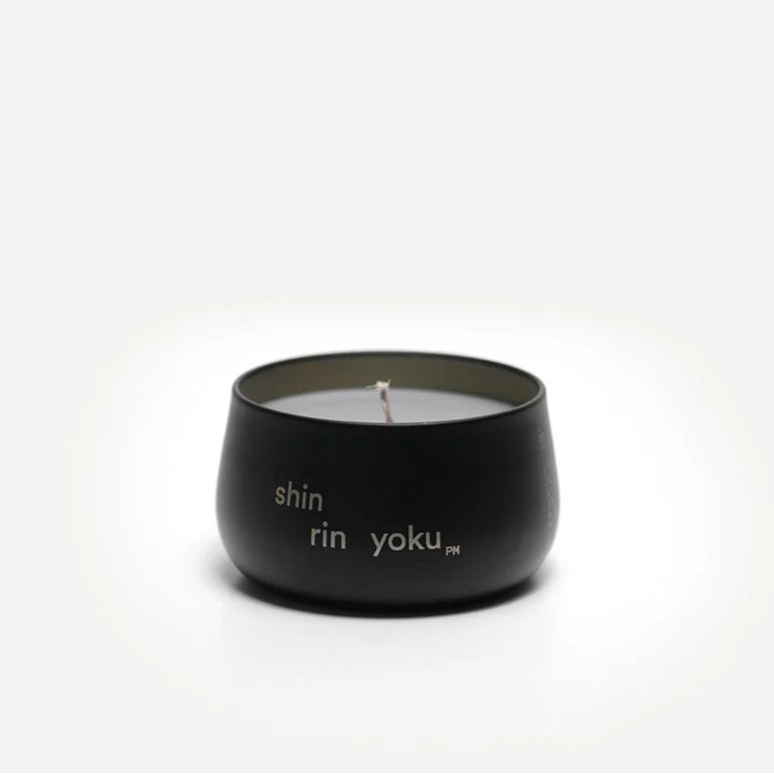 Black candle with white text on a white background