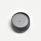 Candle in a black container with 'shin rin yoku' branding on a white background