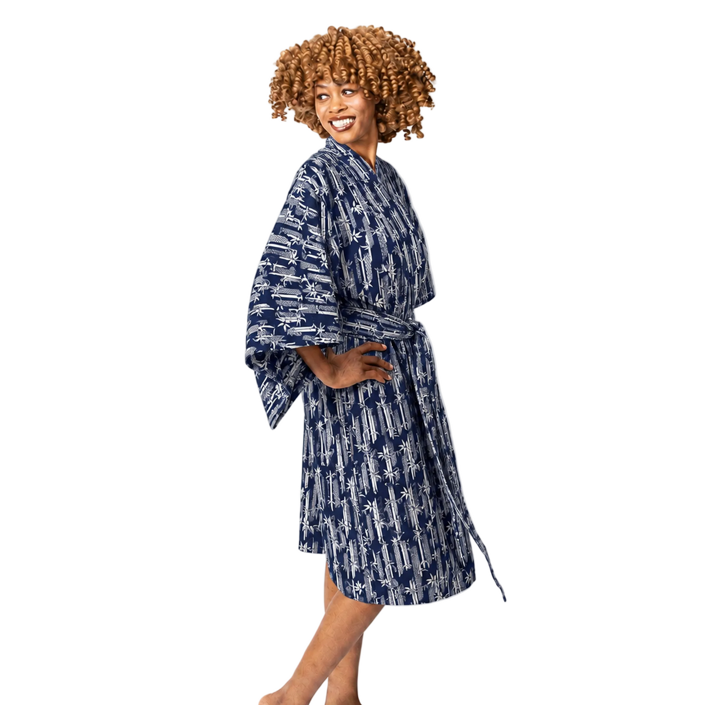 A woman modeling a navy blue and white patterned bathrobe against a plain white studio background.